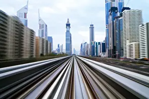 Gulf State Prints: Opened in 2010, the Dubai Metro, MRT, in motion along Sheikh Zayed Road at dusk, Dubai