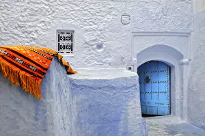 Chefchaouen Gallery: Orange blanket in the bluish Chefchaouen medina. Morocco