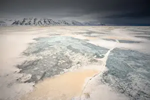 Sea Ice Prints: Orange sand from the Sahara desert blown north up to Billefjorden, Spitsbergen, Svalbard