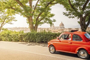Original old red Fiat Cinquecento (500) with Florence Cathedral in background, Tuscany