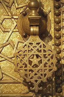 Ornate handle on gilt door at entrance to the Royal Palace