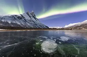 Otertinden, one of the mythical peaks of Norwegian Lapland illuminates by moon with