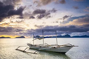 Province Of Palawan Prints: Outrigger boat at sunset on Dolarog Beach, El Nido, Palawan, Philippines