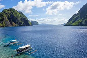 Province Of Palawan Prints: Outrigger boats anchored at Matinloc Island on the Tapiutan Strait between Tapiutan