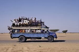 Sudan Gallery: An over-crowded old Bedford bus travels along the main