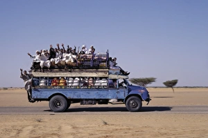 Islamic Dress Gallery: An over-crowded old Bedford bus travels along the main