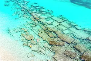 Two People Prints: Overhead view of cheerful boy with mother enjoying floating in a blue lagoon