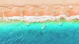Leeward Islands Prints: Overhead view of waves of blue sea breaking on pink sand beach in a tropical lagoon
