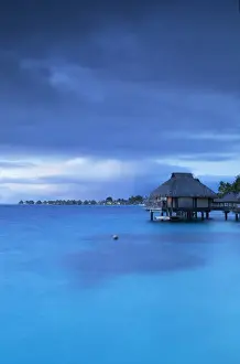 Overwater bungalows of Le Maitai Hotel and Intercontinental Bora Bora Le Moana Resort at dawn