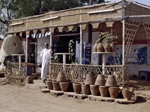 Islamic Dress Gallery: The owner of a roadside shop waits for customers on