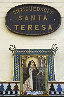 Pray Prints: A painted ceramic mural depicting Santa Teresa praying before a cross