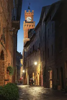 Ancient Building Prints: Palazzo Borgia rising tall above the small village of Pienza at twilight in Val d'Orcia
