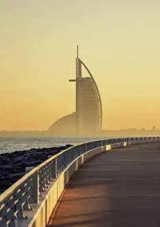 Palm Jumeirah Boardwalk and Burj Al Arab Hotel at sunrise, Dubai, United Arab Emirates
