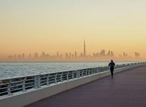 Images Dated 12th January 2018: Palm Jumeirah Boardwalk and City Centre Skyline at sunrise, Dubai, United Arab Emirates