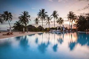 Palms reflecting in swimming pool at sunset, Maldives
