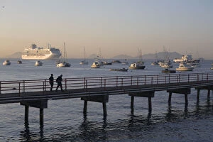 Panama City Gallery: Panama, Panama City, People walking along jetty with a Cruise ship sailing in The