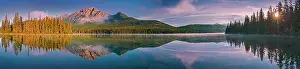 Panorama of Pyramid Mountain reflected in Pyramid Lake at sunrise. Jasper National Park, Alberta, Canada