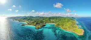 West Indies Prints: Panoramic aerial of a green forest surrounded by the crystal water of Caribbean Sea