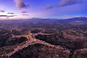 Q1 2024 Prints: Panoramic aerial view of the man-shaped (or star-shaped) illuminated village of Centuripe with Etna volcano