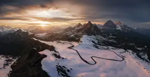 A panoramic aerial view taken from the Giau Pass during an early spring sunset. Dolomites, Italy