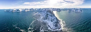 Wave Collection: Panoramic aerial view of waves crashing on snowy mountains, Mefjorden, Senja, Troms county, Norway
