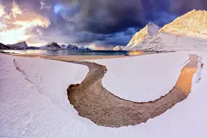 Finish Prints: Panoramic of Haukland beach covered with snow under dramatic clouds at dawn