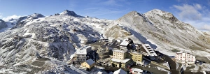 Panoramic view from the Stelvio pass, with a little of snow, and houses and hotels on the Pass Panoramic view from the Stelvio pass, with a little of snow, and houses and hotels on the Pass