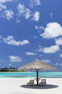 Parasol and sunloungers at Olhuveli Beach and Spa Resort, South Male Atoll, Kaafu Atoll