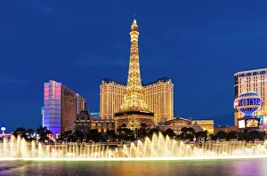 Casino Prints: Paris Las Vegas Hotel and Casino with the Bellagio Fountains at dusk