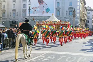 Participants in the Explosion of the Cart festival parading through historic center