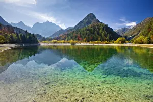 Peaks of Prisojnik and Razor reflected in pools beside the Velika Pisnca River in Autumn