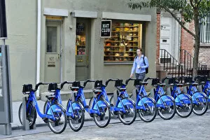 Images Dated 7th October 2013: Pedestrian walking past a rack of Citi Bikes on Spring street, in Soho, Manhattan