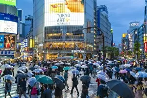 Pedestrians with umbrellas Shibuya Crossing, one of the busiest crossings in the world