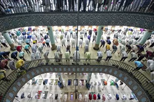 Holy Collection: People come together to pray over several floors of one of the biggest mosques in