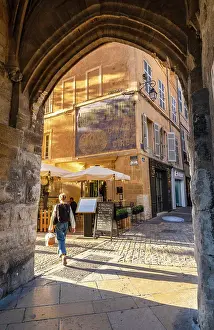 Outdoor Cafe Prints: People Eating at an Outdoor Restaurant with a Faded Advertising Sign on the Wall