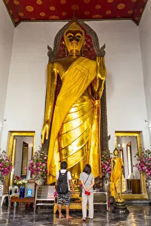 Images Dated 5th August 2020: People looking at a Buddha statue in Wat Pho (Temple of the Reclining Buddha), Bangkok