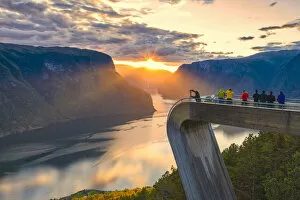 People photographing sunset on the fjord from Stegastein viewpoint, aerial view