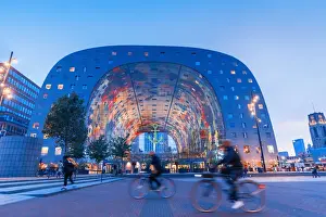 Holland Prints: People riding bikes in front of the Market Hall in Rotterdam on a summer evening