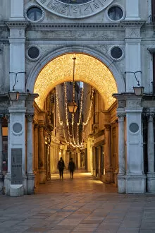 Images Dated 17th March 2020: People walk through the illuminated arcade under the clock Tower, St