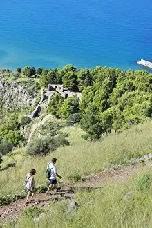 Walkers Prints: People walking at cliff La Rocca, Cefalu, Sicily, Italy, Europe