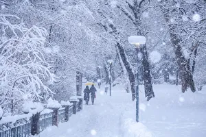 Tiroler Prints: People walking on the Inn Promenade on a snowy day, Innsbruck, Tyrol, Austria
