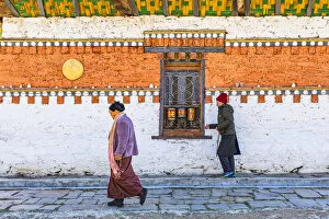 Prayer Gallery: People walking around Jambey Lhakhang, Jakar, Bumthang District, Bhutan