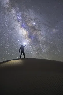 Deserted Gallery: Person admiring the milky way in the sand dunes, Sahara desert, Tunisia, Northern Africa