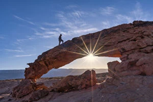 Person on Sunset Arch, Grand Staircase Escalante National Monument, Utah, USA