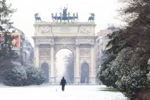Historical Center Prints: One person walks in the snow in front of Arch of Peace. Milan, Lombardy, Northern Italy