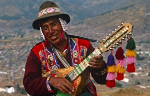 Peru, Cusco. An itinerant Quechuan musician plays his bandurria in the hills above Cusco Peru, Cusco. An itinerant Quechuan musician plays his bandurria in the hills above Cusco