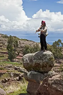Puno Prints: Peru, A Quechua-speaking man plays his flute on Taquile Island