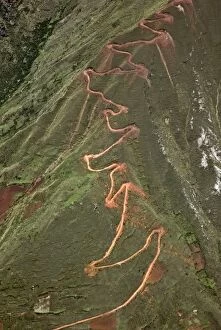 Andes Collection: Peru. A trail zigzags up a steep ridge on the Andean Mountains east of Cusco