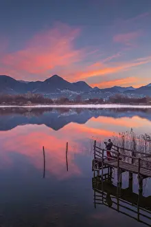 One Person Prints: A photographer captures a sunrise from Alserio lake