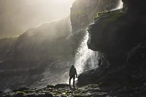 Adventure Gallery: A photographer enjoying a beautiful atmosphere on the coast close to Mikladalur, island of Kalsoy